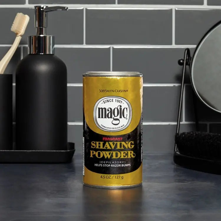 A can of Magic fragrant shaving powder, 4.5 oz / 127 g, is placed on a bathroom counter with a toothbrush, soap dispenser, and mirror in the background.