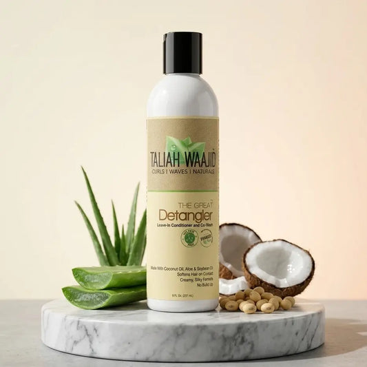 Taliah Waajid The Great Detangler bottle displayed with coconut and aloe