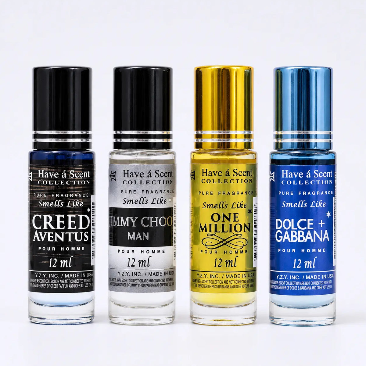 Four perfume rollerball bottles from Have a Scent Collection lined up on a white background. From left to right: Creed Aventus in dark blue, Tommy Choo Man in black and white, One Million in metallic gold, and Dolce + Gabbana in metallic blue.