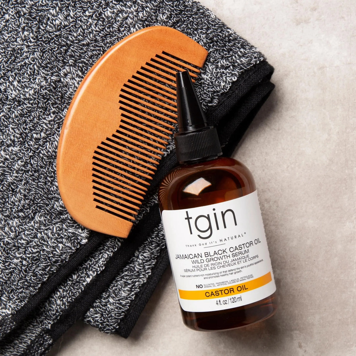 TGIN Jamaican Black Castor Oil Growth Serum 4 oz — serum bottle with comb and towel