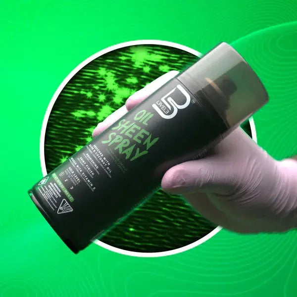 Close-up of a gloved hand holding L3VEL3 Oil Sheen Spray