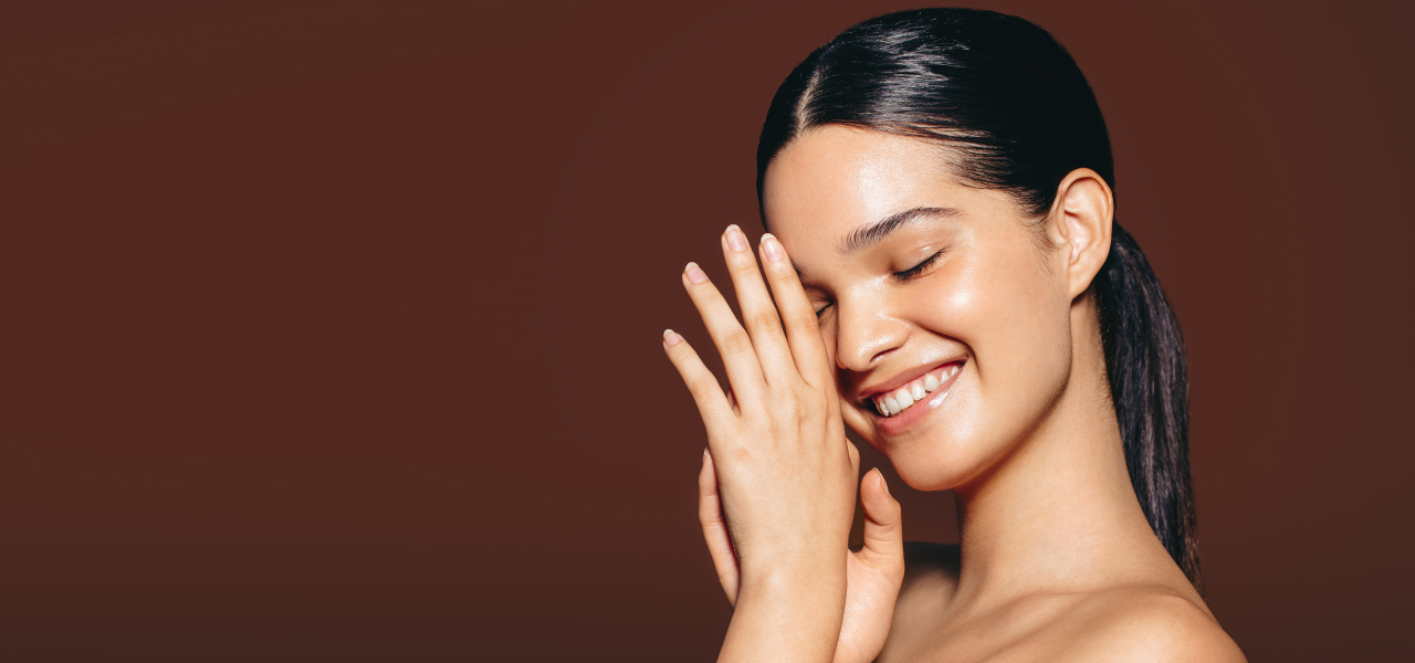 Woman with smooth skin against a brown background