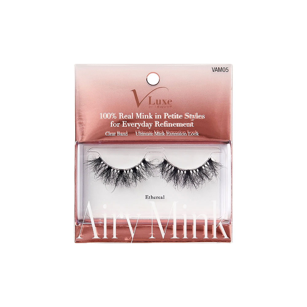 VAM05_main "A single false eyelash. The eyelash is black and features a dramatic, voluminous design with multiple layers of wispy, crisscrossing fibers. The fibers vary in length, creating a full and fluttery appearance. The base of the eyelash is slightly curved to fit the natural contour of the eyelid."