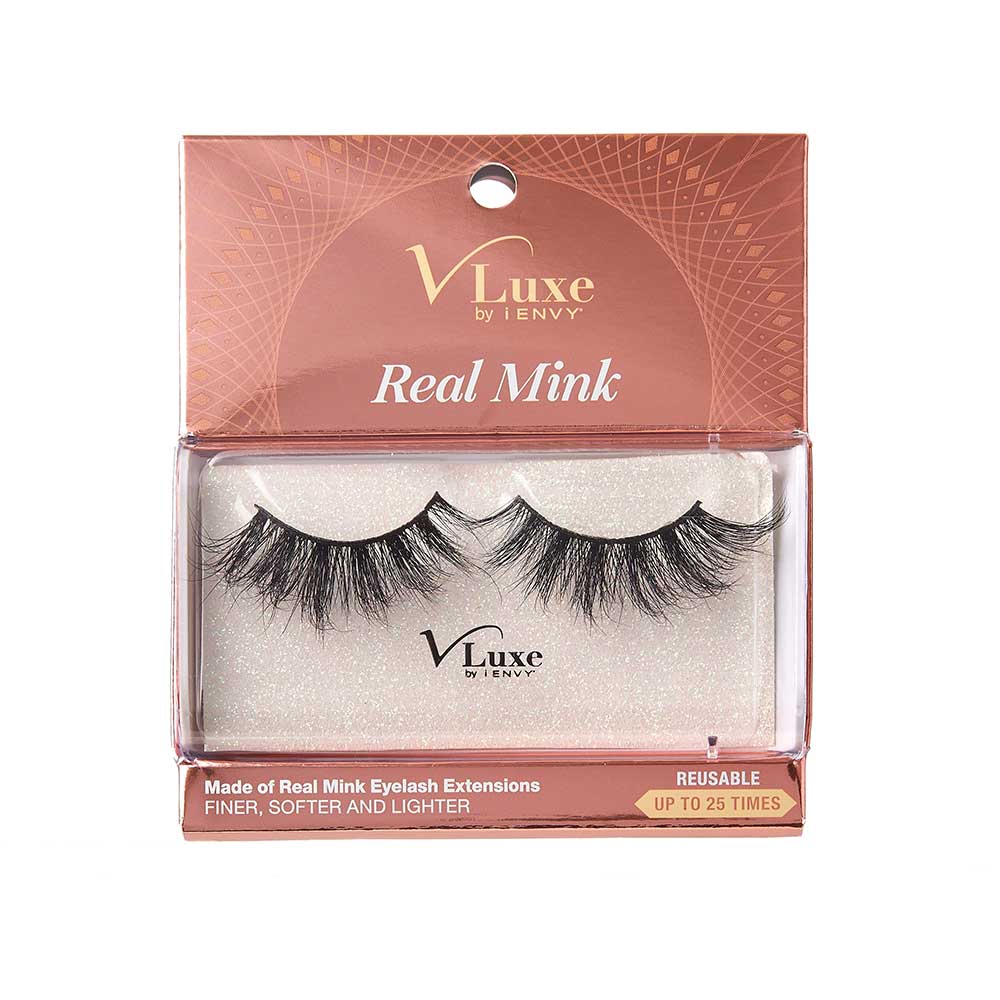 VLEC03_main "A package of false eyelashes. The packaging is transparent, allowing the eyelashes to be clearly visible. The eyelashes are thick and voluminous, with a slightly curled design. The brand name "V Luxe by i-Envy" is printed on the packaging, along with the style name "Velvet Rose." The background inside the packaging has a subtle, glittery texture."