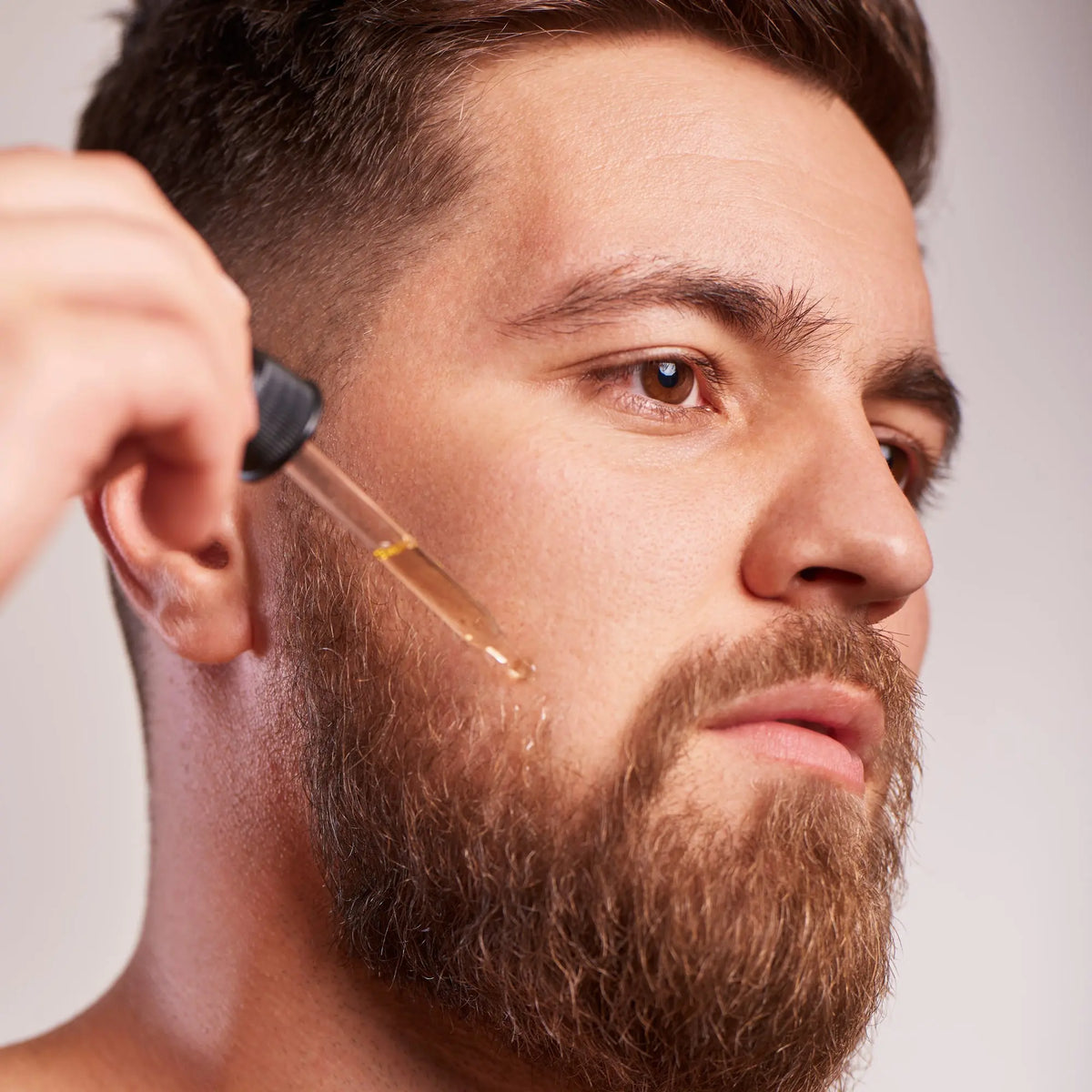 Absolute Beard Oil, shown on a model