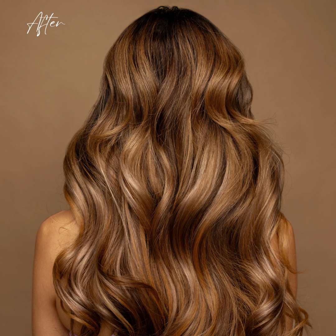Long, wavy hair with brown and blonde color gradient on a brown background