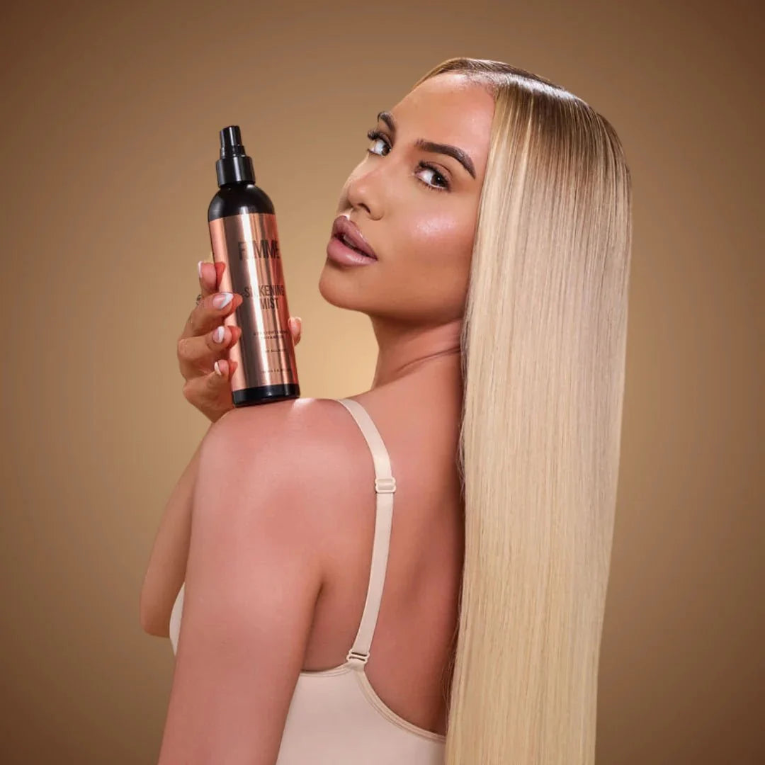 Model with long straight blonde hair holding Femme Silkening Mist