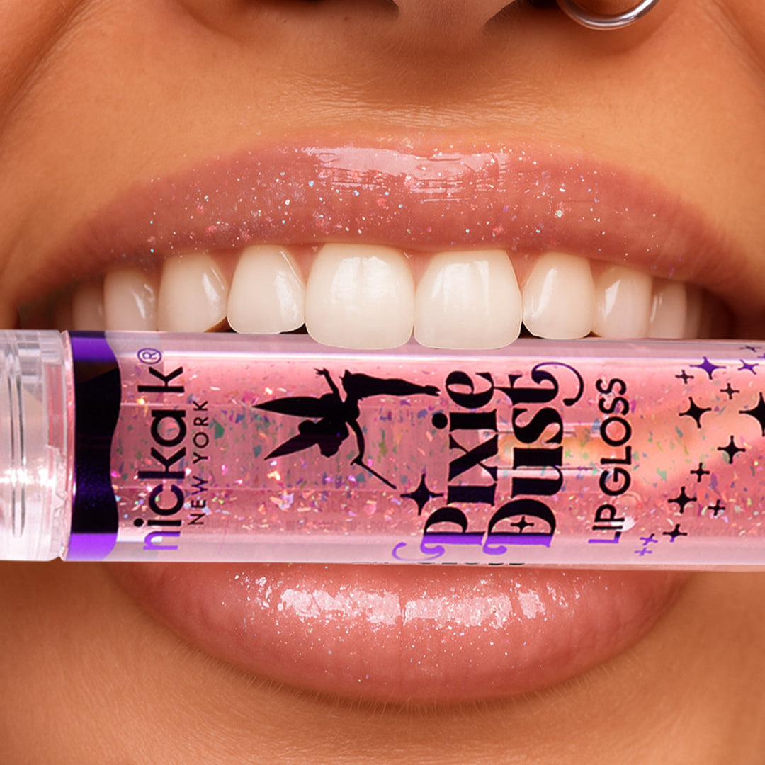 Model holding Nicka K Pixie Dust Lip Gloss by glossy lips