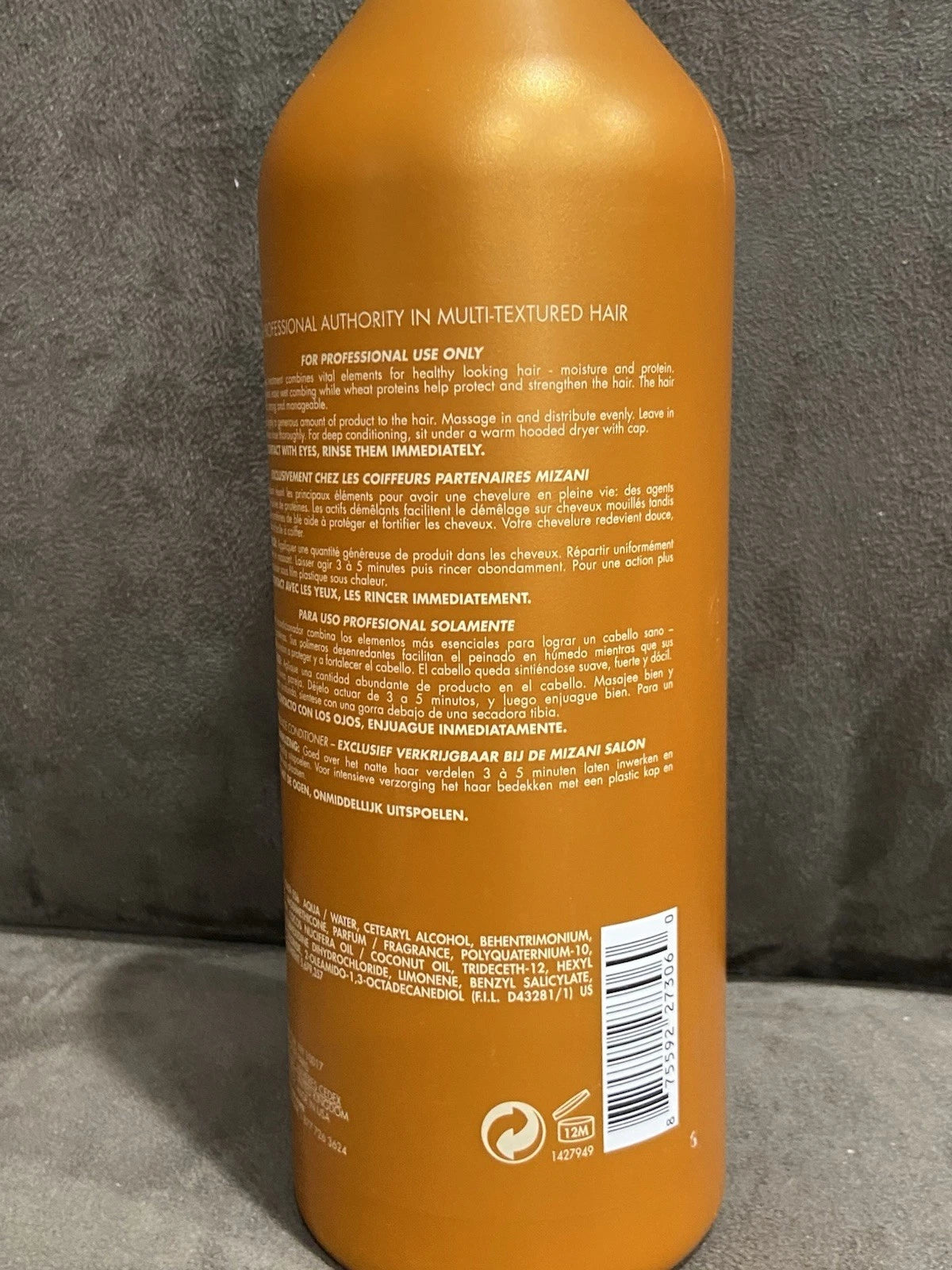 Yellow cylindrical MIZANI Thermasmooth conditioner bottle with white text, barcode, and European Union logo on back.